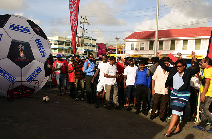 Minister of Public Telecommunications Cathy Hughes celebrates after scoring a penalty at the Stabroek Market Square. (Adrian Narine photo)