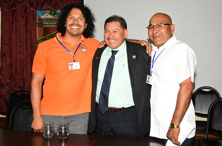 Minister of Indigenous Peoples’ Affairs, Sydney Allicock embraces Toshaos Joel Fredericks and Lenox Shuman, the chair and deputy chair respectively, of the National Toshaos Council