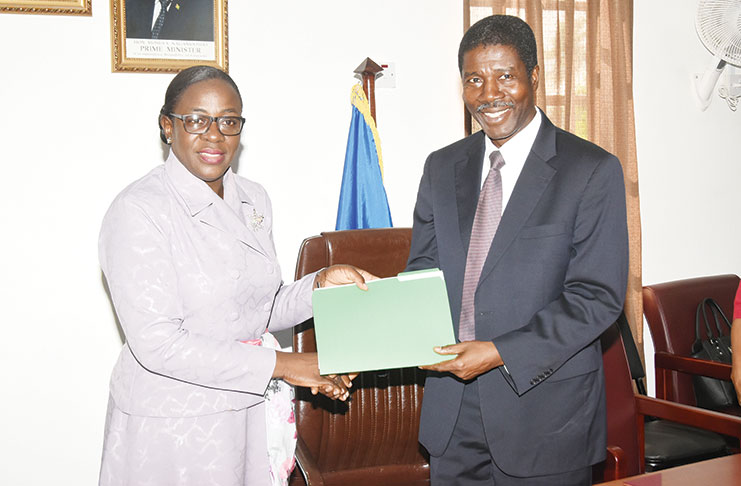 Education Minister Nicolette Henry (left) receives the signed agreement from OAS representative Jean Ricot Dormeus (Adrian Narine photo)