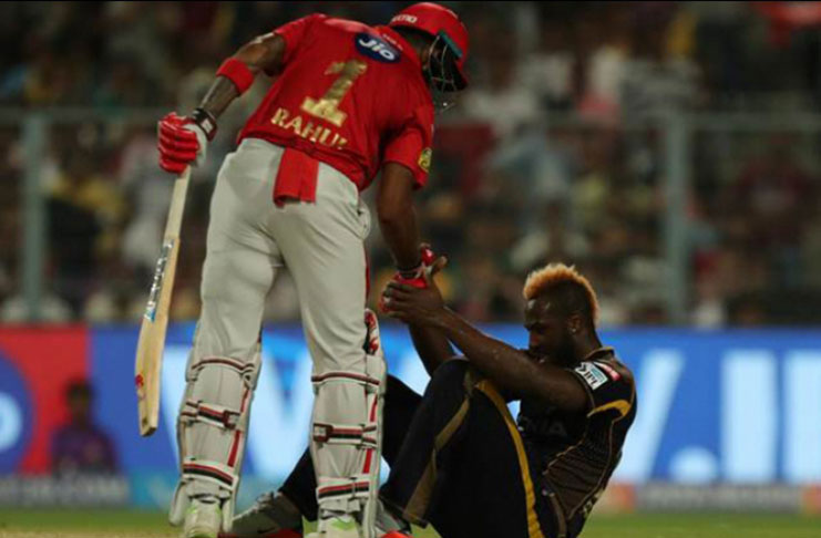 KKR's Andre Russell being assisted by Kings XI Punjab Chris Gayle.