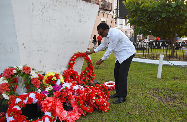 Minister of Legal Affairs Basil Williams, pays respect to the works of Hubert Nathaniel Critchlow (photo by Samuel Maughn)