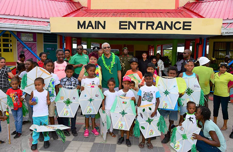 President David Granger with children at the Yarrowkabra Primary School during his kite-distribution exercise on Friday