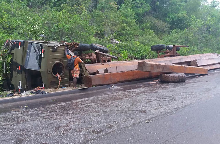 When it rains it pours! This logging truck was proceeding to Georgetown from Linden on the Soesdyke-Linden Highway amid heavy showers when it turned over (Photos by Svetlana Marshall)