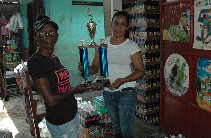 R&F Wholesale Depot Amrita Singh (right) makes the presentation of trophies to Organising Committee member Jane Chase yesterday at the Bourda Market location.