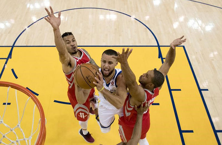 Golden State Warriors guard Stephen Curry (30) shoots the basketball against Houston Rockets guard Gerald Green (14) and guard Eric Gordon (10) during the first half in game three of the Western conference finals of the 2018 NBA Playoffs at Oracle Arena..( Mandatory Credit: Kyle Terada-USA TODAY Sports