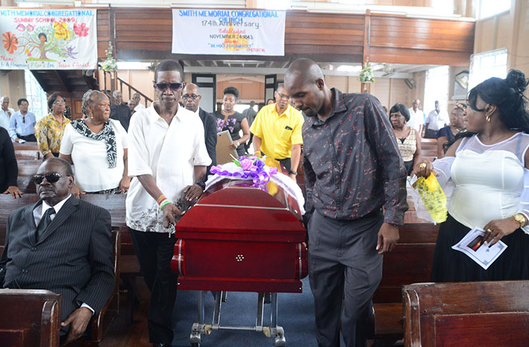 Family members bear the remains of Mr. George Baird into the Smith Memorial Congregational Church
