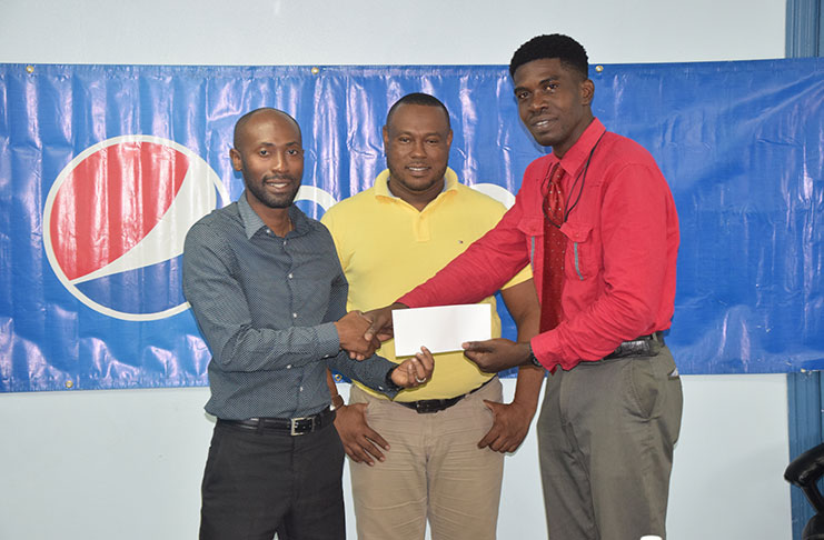 From left, DDL Brand Manager Larry Wills hands over the company’s sponsorship to Petra executive Mark Alleyne in the presence of co-director Troy Mendonca.
