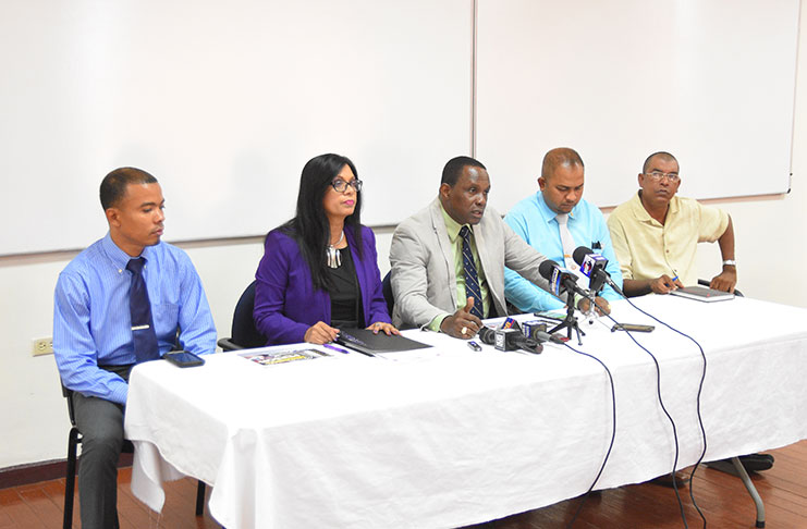 Crime Chief, Paul Williams (centre) and women's rights activist, Dianne Madray, flanked by members of the Major Crime Unit during the press conference.