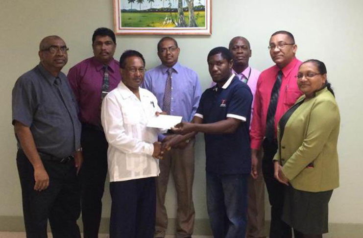 MSC president Winston Semple (right) collects the cheque from NBS’ Seepaul Narine in the presence of representatives of both entities.