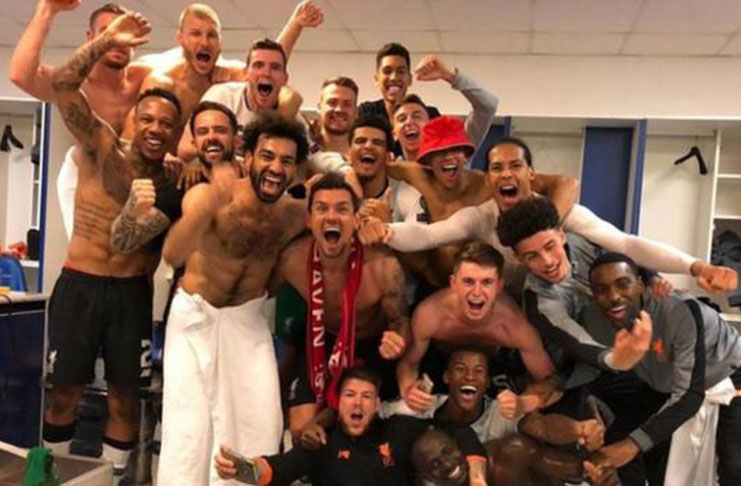 Liverpool players celebrate in the dressing room after reaching the Champions League final. (BBC Sport)