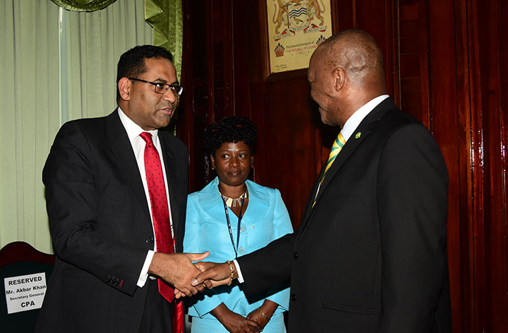 Secretary-General to the Commonwealth Parliamentary Association, Mr Akbar Khan, shares a light moment with Minister of State Joseph Harmon and a staff of Parliament