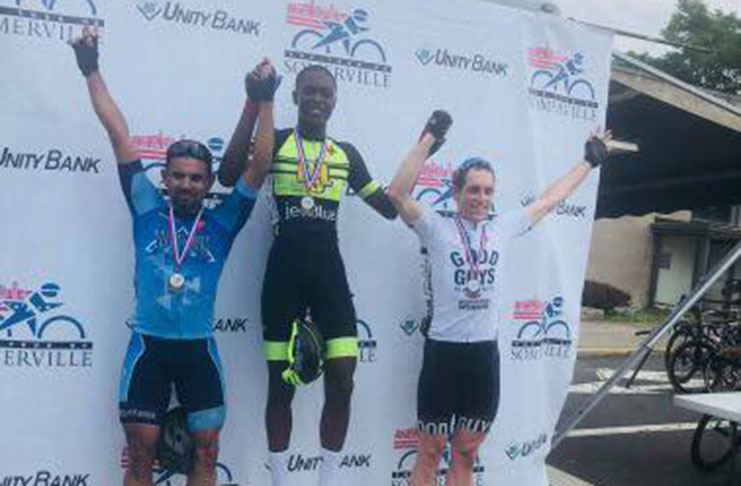 Romello Crawford atop the podium (centre) after winning his race on Saturday