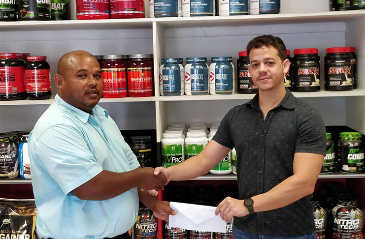 Jamie McDonald (right) of Fitness Express hands over the sponsorship package to GAPLF treasurer, Colin Austin.