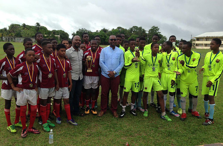 The Frank Watson presentation: Milerock (in burgundy and white) at left with UDFA president Terrence Mitchell, GFF president Wayne Forde and Botofago players (in lime green) pose after receiving their trophies and medals.