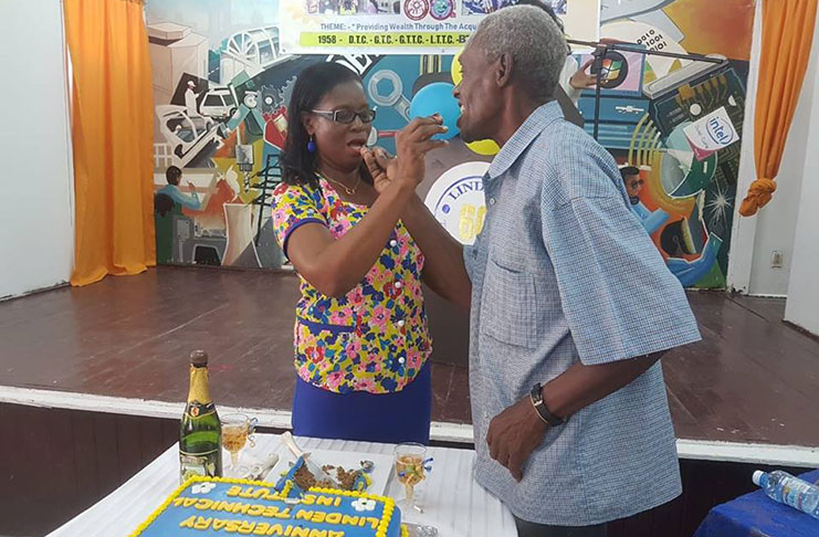 LTI Principal (ag) Ms Shurla Brotherson sharing the 60th Anniversary cake with past student Mr Desmond Bacchus