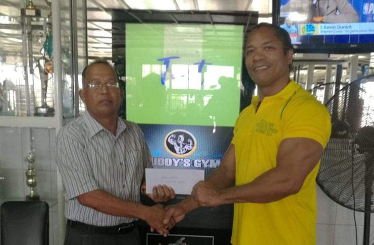 GAPLF committee member, Martin Webster (left) receives the sponsorship package from Buddy’s Gym Manager, Mr Crush Pharbo.