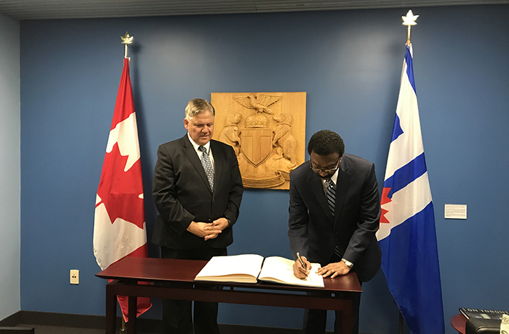 Attorney General and Minister of Legal Affairs Basil Williams signing the Toronto City Hall’s Guest Book in the presence of Councillor Jim Karygiannis