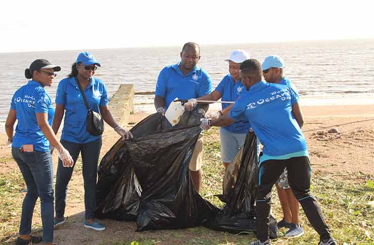Sol Guyana representatives amongst others during Saturday’s cleanup exercise in observation of World Oceans Day