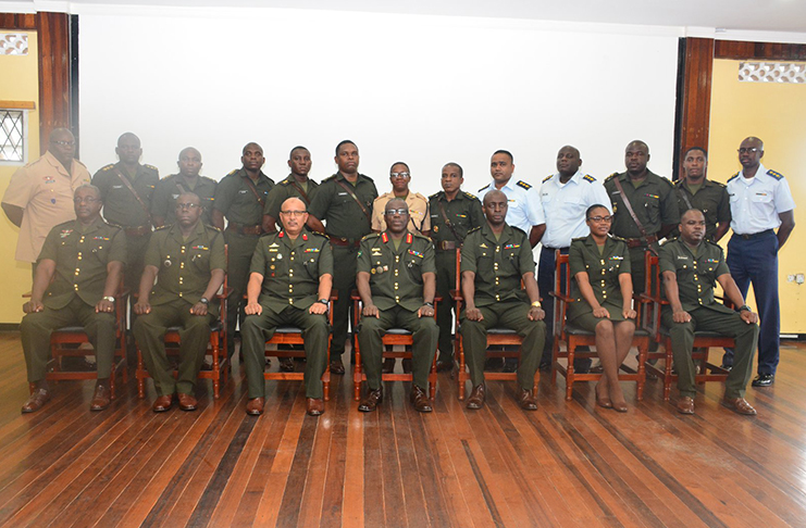 Chief of Staff of the Guyana Defence Force, Brigadier Patrick West and other officers seated, pose with the participants of the course