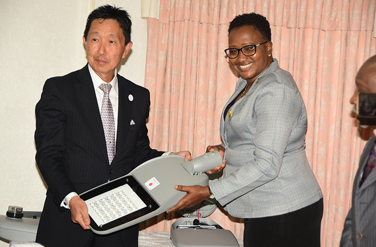 Minister within the Ministry of Public Infrastructure, Annette Ferguson, receives one of the many LED street lamps provided by the JICA through the Japanese Government from Japan’s Ambassador to Guyana Mitsuhiko Okada, Wednesday. (Adrian Narine)