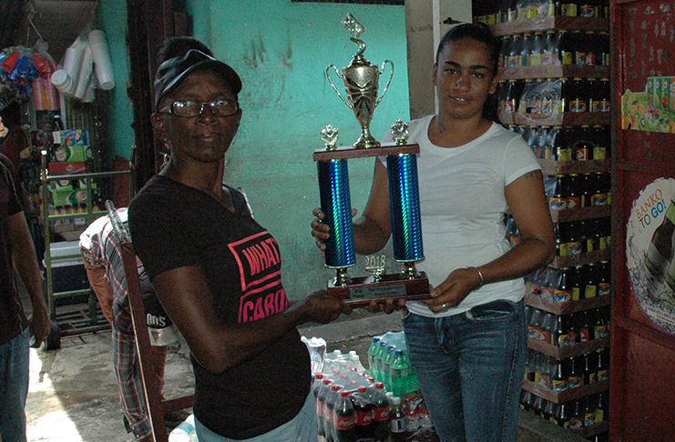 R&F Wholesale Depot’s Amrita Singh (right) presents the trophies to Jane Chase while Wiltshire looks on.