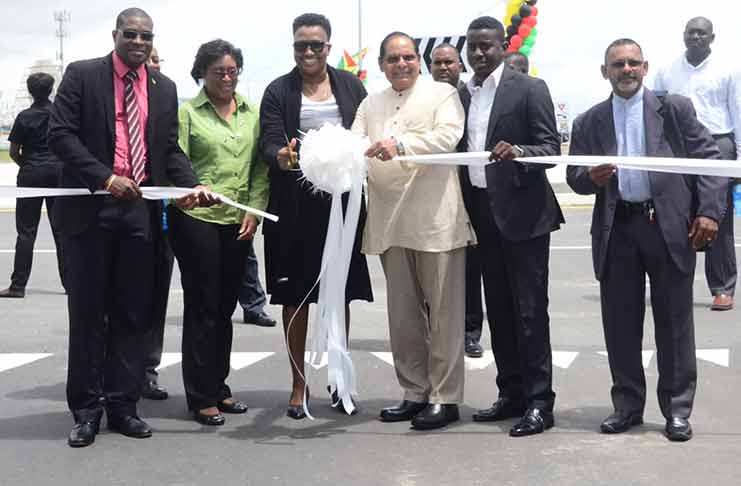 Prime Minister Moses Nagamootoo joined Minister within the Ministry of Public Infrastructure Annette Ferguson as she cuts the traditional
ribbon to officially declare the Kitty Roundabout open on Monday. They were joined by Ministers of Public Infrastructure and
Telecommunications, David Patterson and Catherine Hughes (left and second left respectively) and a representative of the National
Front Alliance, Sheik Yassen (right). Also in photo is Deputy Mayor, Akeem Perter (Delano Williams photo)