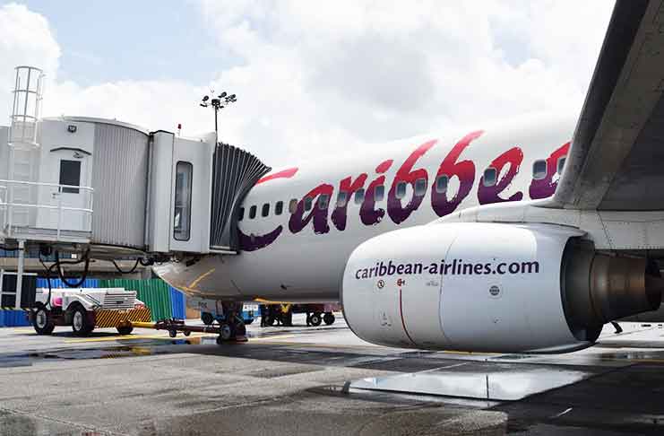 A Caribbean Airlines flight readies for take-off as outgoing passengers at the Cheddi Jagan International Airport on Friday began using for the first time the
boarding corridor and bridge that were recently installed under the US$150M airport expansion project (CJIAC photo)