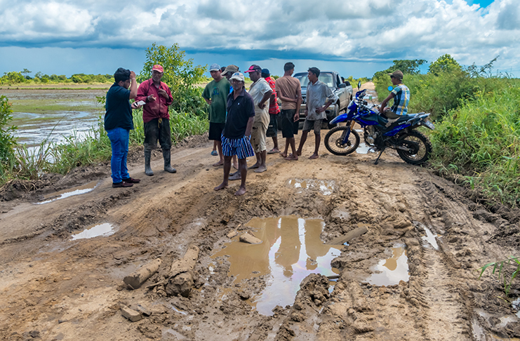 Farmers contemplating the next move after speaking to the Guyana Chronicle on Tuesday (Delano Williams photo)