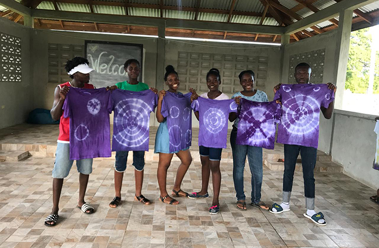 Some of the participants of the Women of Purpose project, proudly displaying the tie-dye work they did