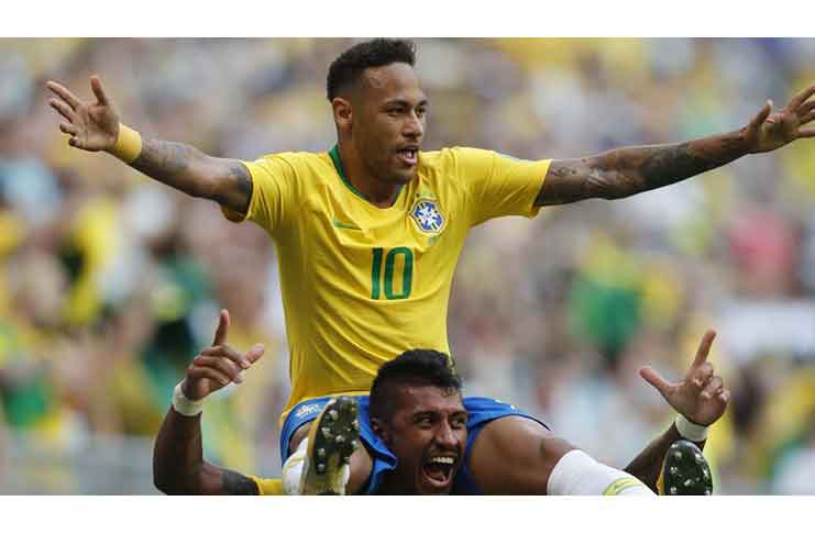 Brazil's Neymar, top, celebrates with team mate Paulinho after scoring his side's opening goal. (Hindustan Times)
