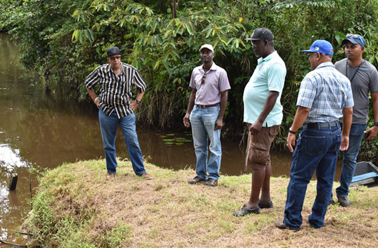 GWI officials near the Kaituma River where traces of mercury were discovered (DPI photo)