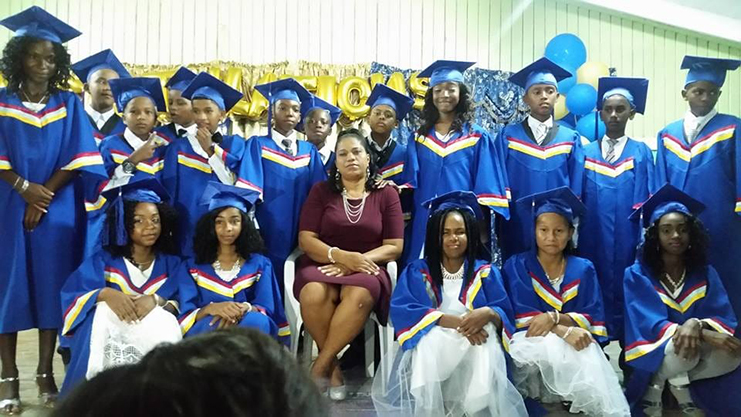 The 2018 graduation class of the Howell Wilson Primary and teacher Yvonne Nazier