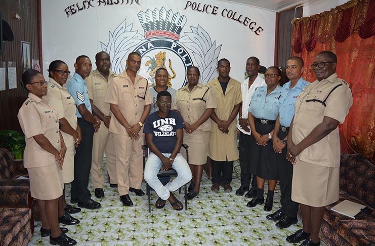 Police Sergeant Heron Lensford Anderson, seated,  and Acting Commandant of the Police Training School, Jairam Ramlakhan (on his right) with senior and junior ranks of the training school