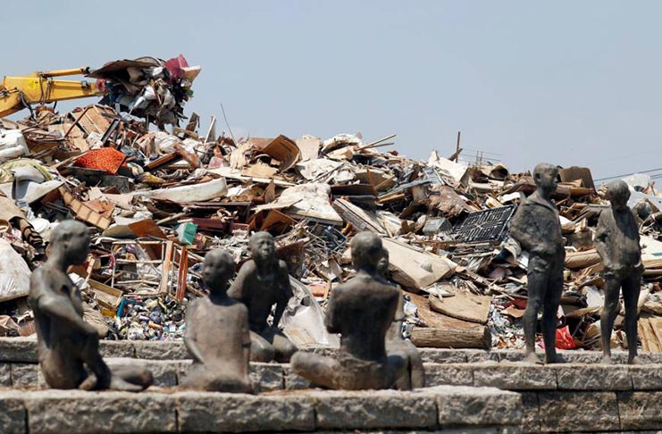 Household waste collected in the wake of heavy flooding in western Japan is piled up at a temporary collection site in Kurashiki, Okayama Prefecture, on Saturday (Reuters)