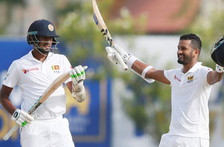 Sri Lanka's Dimuth Karunaratne (R) celebrates his century next to captain Suranga Lakmal. (REUTERS/Dinuka Liyanawatte)