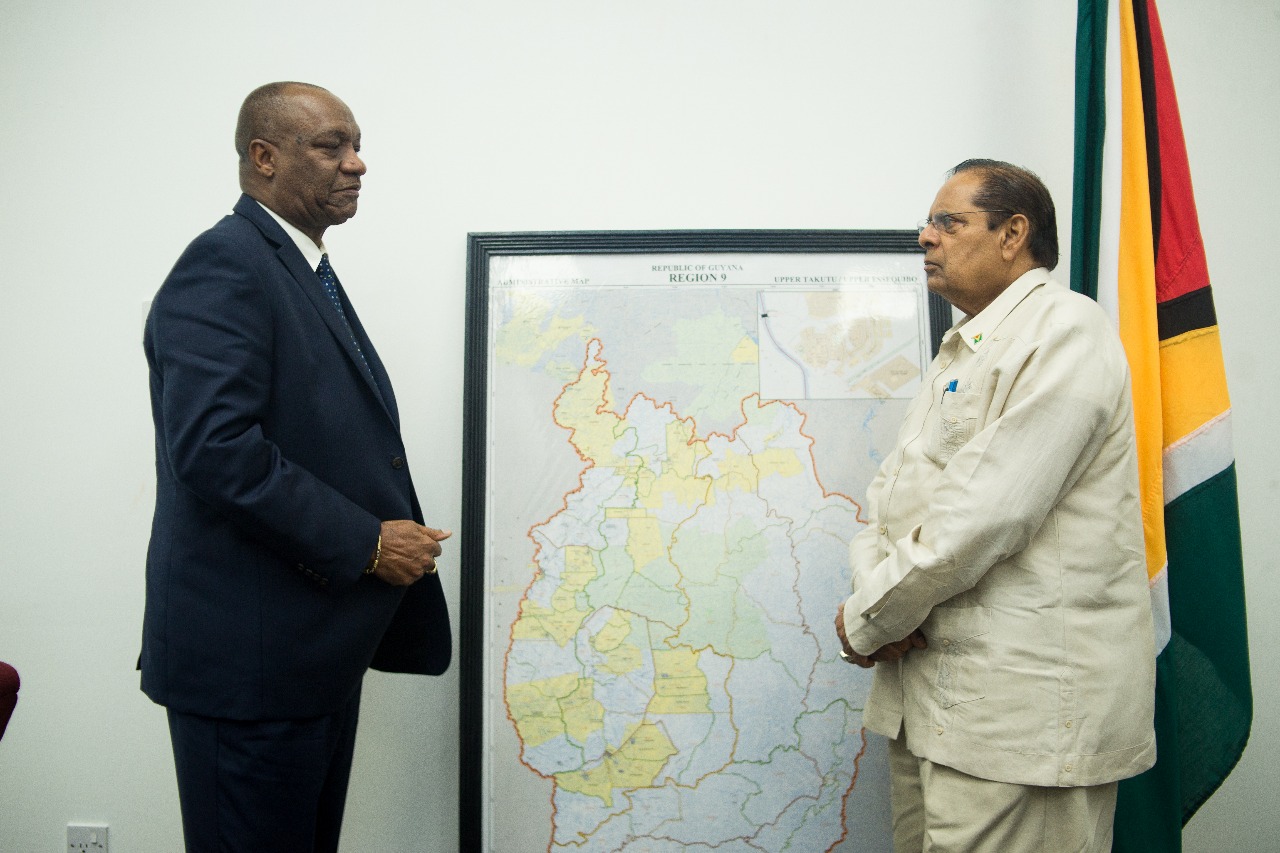 Prime Minister , Moses Nagamootoo , who is performing the duties of President , during a meeting with Minister of State , Joseph Harmon.