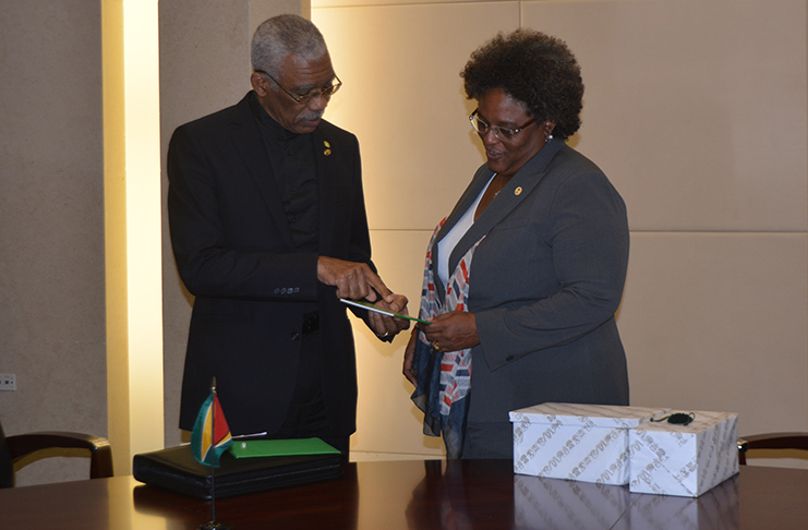 President David Granger presenting Prime Minister of Barbados Mia Mottley one of his booklets on Guyana’s Green State Development Strategy shortly after they had concluded bilateral talks
