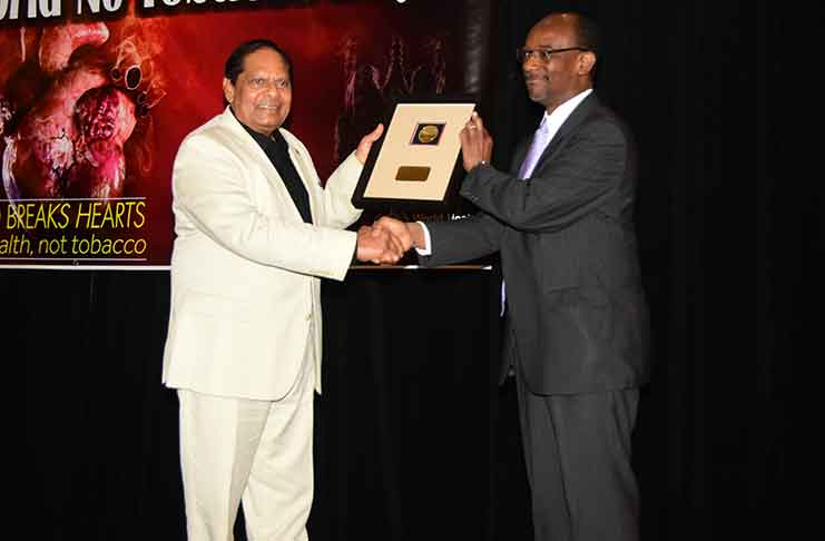 Prime Minister Moses Nagamootoo receiving the Tobacco Day Award from Director of Non-Communicable Diseases and Mental Health, Dr. Anselm Hennis (Photos by Adrian Narine)