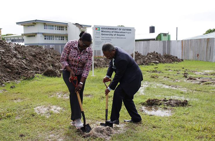 Minister of Education Nicolette Henry and Vice-Chancellor, Professor Ivelaw Griffith, turning the sod (Ministry of Education photo)