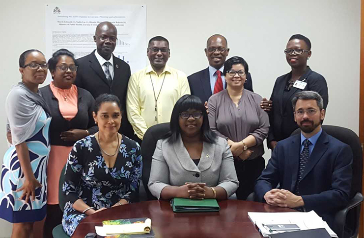 Seated (L-R): Dr Renee West, Honourable Dr. Karen Cummings and Dr. Rob Glaubius. Standing (L-R): Ms. Karen Yaw, Ms. Maria Niles, Dr. Martin Odiit, Dr. Shamdeo Persaud, Dr. Morris Edwards, Dr. Nadia Liu and Dr. Rhonda Moore