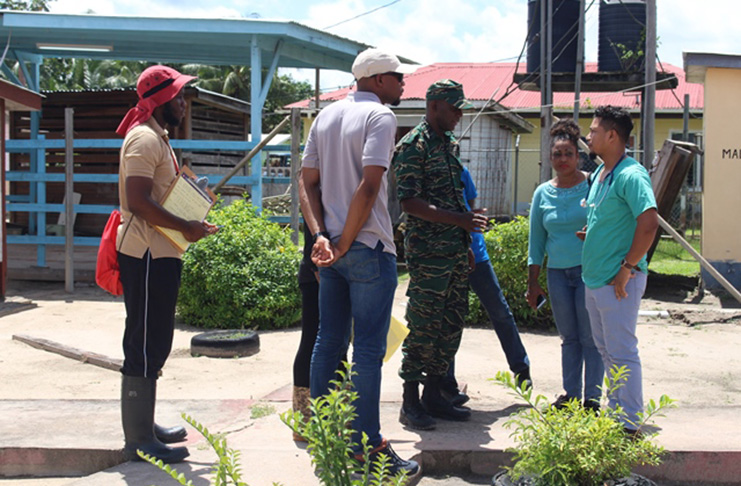 Lt. Col. Kester Craig in discussion with a representative from the community of Kwakwani