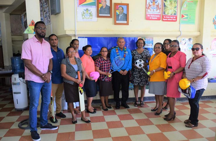 Director of Sport Christopher Jones and Minister of Social Cohesion Dr George Norton with  recipients of the sport equipment