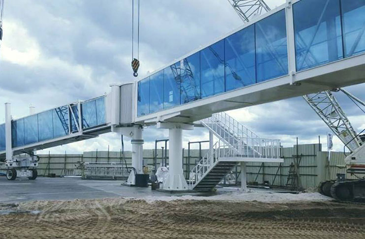 A passenger boarding bridge being installed at the CJIA (photo courtesy of Minister of Public Infrastructure, David Patterson)