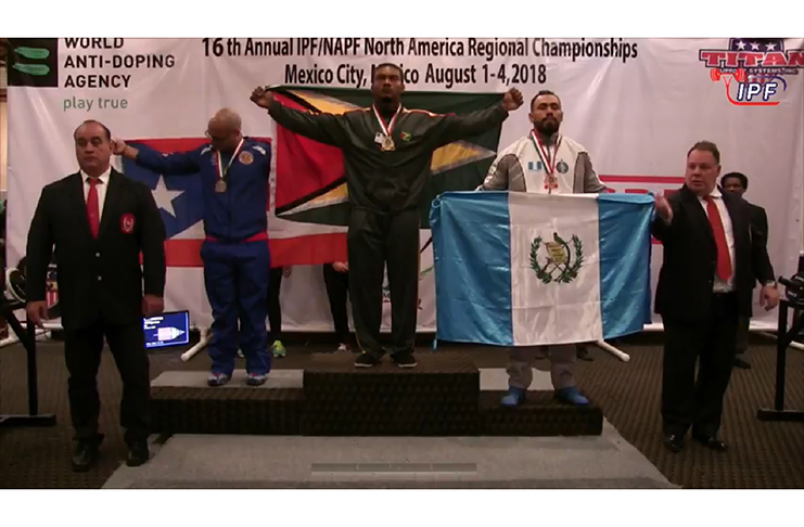Carlos Petterson-Griffith stands proudly on the podium after winning the gold medal in the Men’s Raw 93kg Open.
