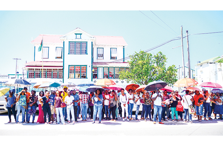 A gathering of teachers eagerly await news outside of the Ministry of Education on Thursday as their union executives negotiate inside (Delano Williams photo)