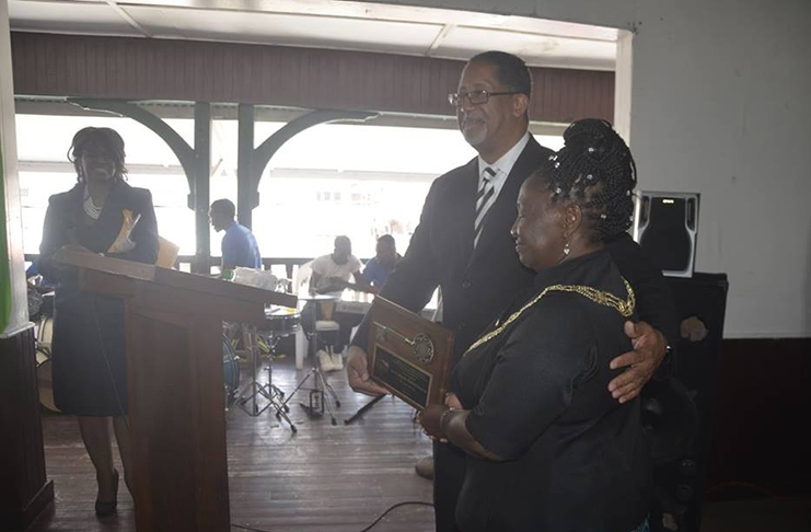 Stonecrest Mayor Jason Larry hands over the traditional 'Key to the City' to New Amsterdam Mayor Winifred Haywood at the New Amsterdam Town Hall