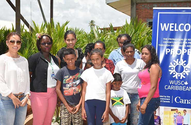 Representatives of PROPEL share a moment with farmers and children from Hope Estate (Samuel Maughn photo)