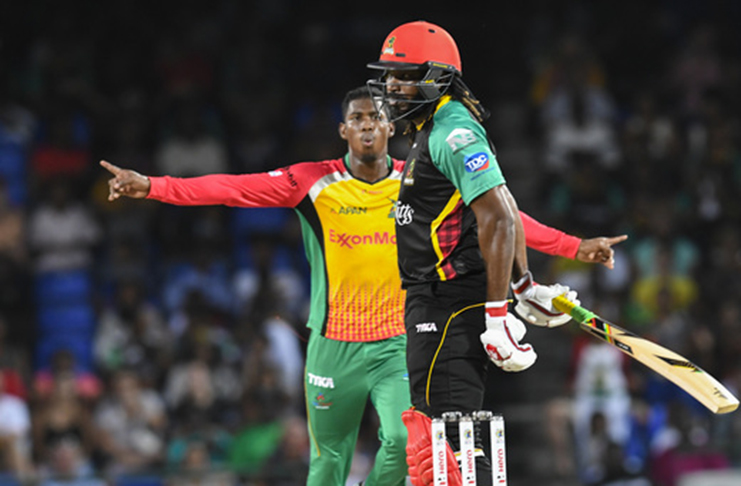 Chris Gayle (R) of St Kitts & Nevis Patriots is dismissed by Keemo Paul (L) of Guyana Amazon Warriors during match 19 of the Hero Caribbean Premier League at the Warner Park Sporting Complex on August 25, 2018 in Basseterre, St Kitts. (Photo by Randy Brooks - CPL T20/Getty Images)
