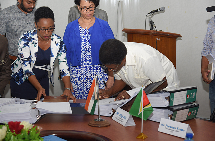 CEO of NDIA, Fredrick Flatts signing the agreement for the construction of the pumps on Monday (Samuel Maughn photo)