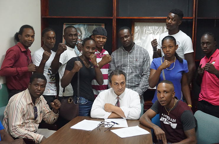 Boxers, who will be engaged in the GBBC’s `Young Guns, the Proven Ones’ fight card come September 22, ink their respective contracts in the presence of GBBC president Peter Abdool (front row, centre).